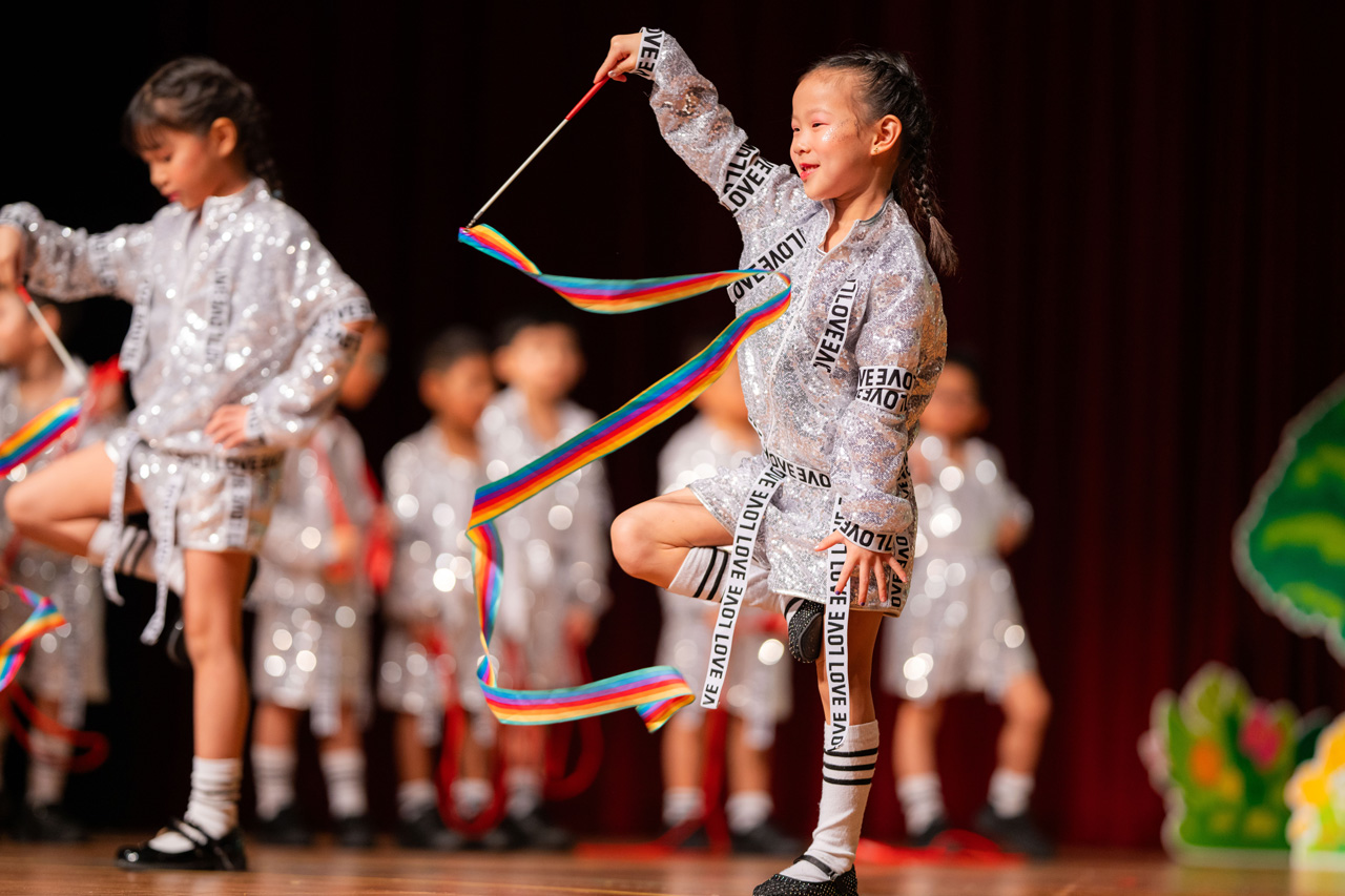 Rhythmic ribbons, sparkling smiles, and a flurry of fun! Our K2 children taking center stage with dazzling moves.